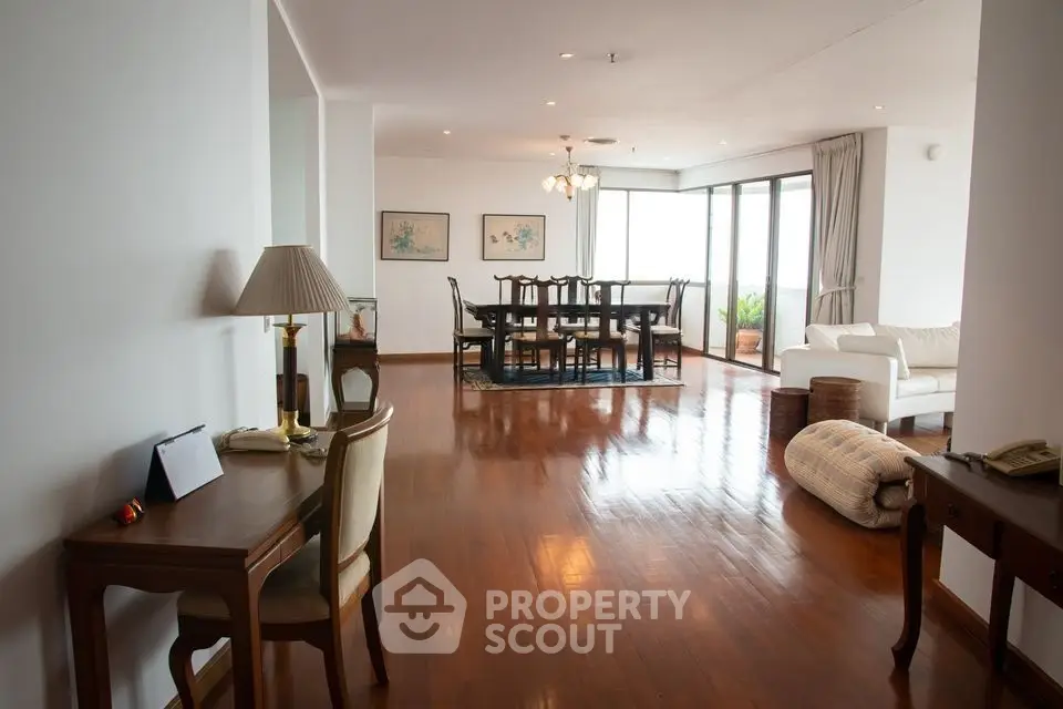 Spacious living room with elegant dining area and polished wooden floors in a luxury apartment.