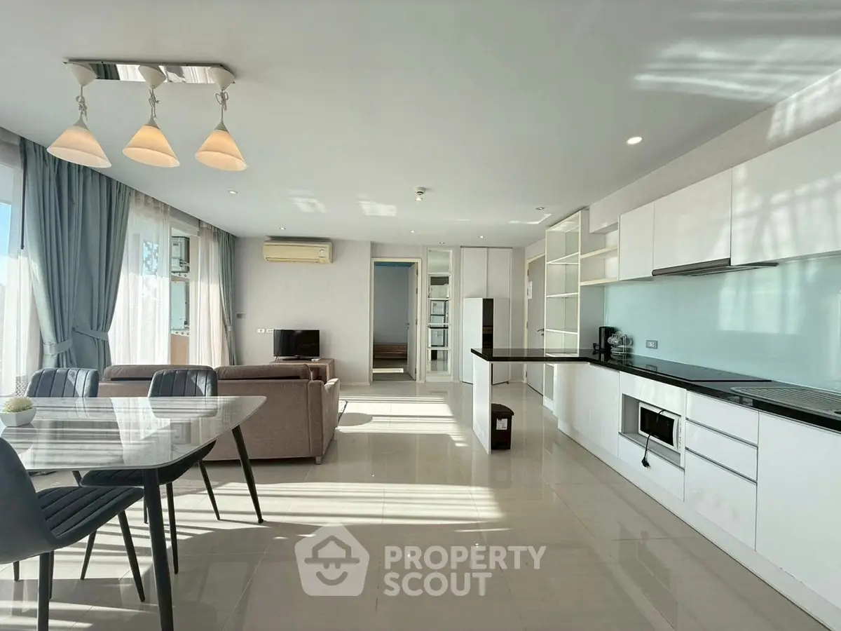 Spacious modern living room with open kitchen and elegant dining area