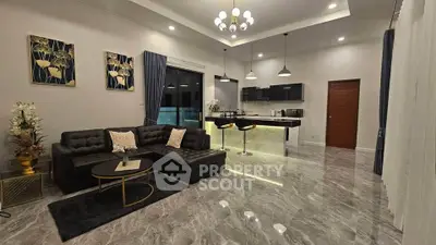 Luxurious open-plan living room with modern kitchen and elegant decor