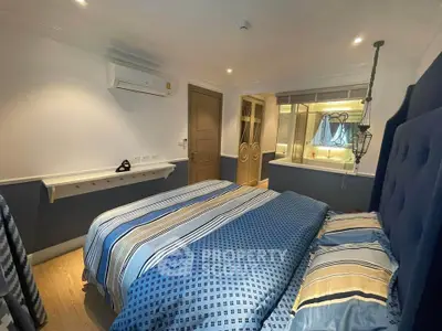 Cozy bedroom with modern decor and stylish bedding in a well-lit space.