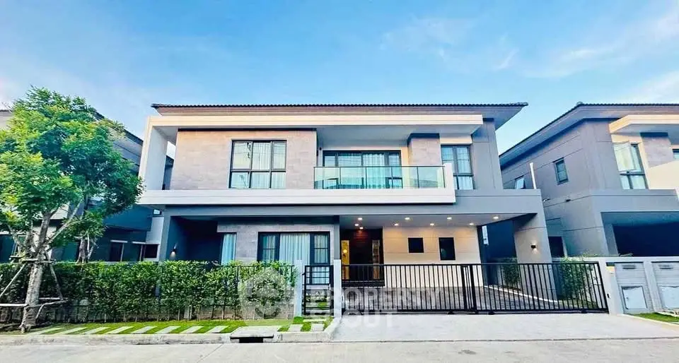 Modern two-story house with sleek design and spacious balcony in a serene neighborhood.