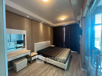 Luxurious bedroom with modern decor and ample natural light in prime real estate location.