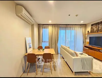 Modern living room with dining area and large window view