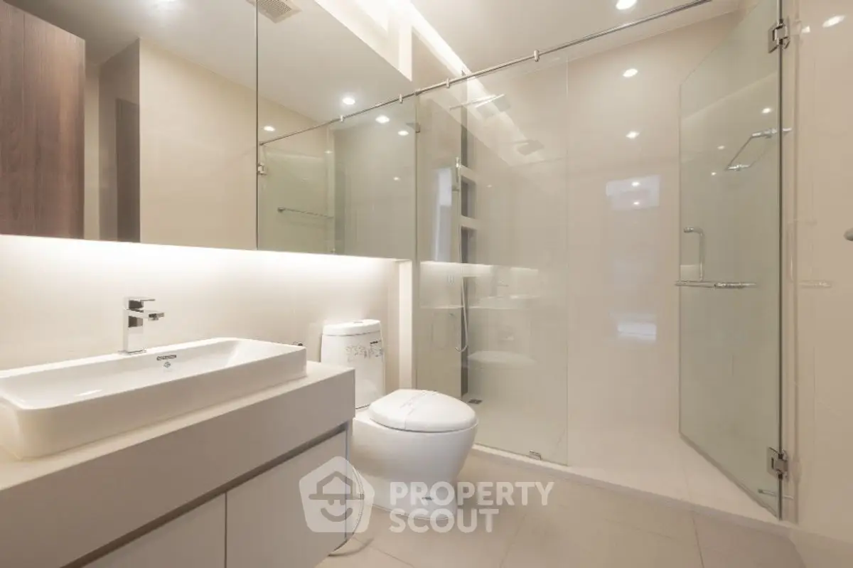 Modern bathroom with glass shower and sleek fixtures