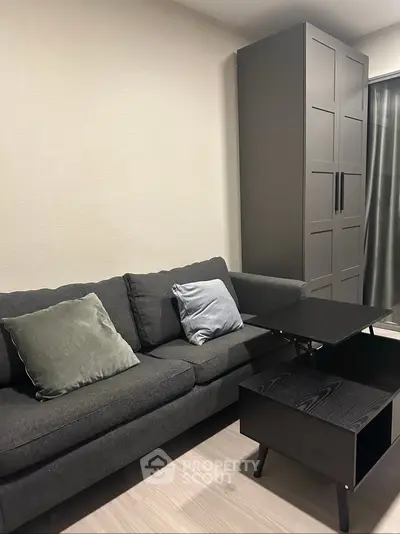 Modern living room with sleek black sofa and stylish coffee table
