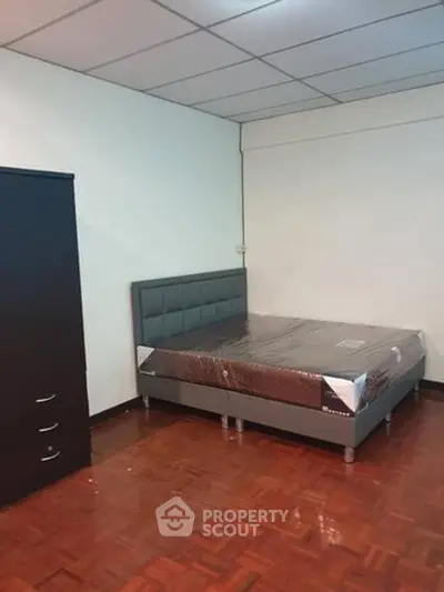 Spacious bedroom with modern bed and wooden flooring