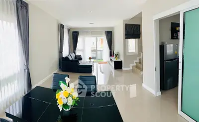 Spacious modern living room with elegant dining area and sleek kitchen