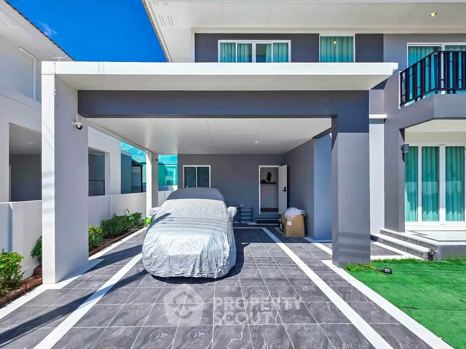 Modern two-story house with covered carport and sleek exterior design.