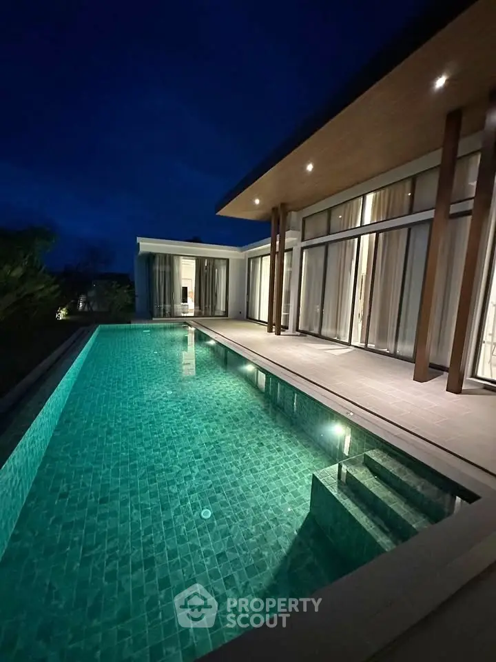 Luxurious modern villa with stunning poolside view at dusk, showcasing elegant architecture and serene ambiance.