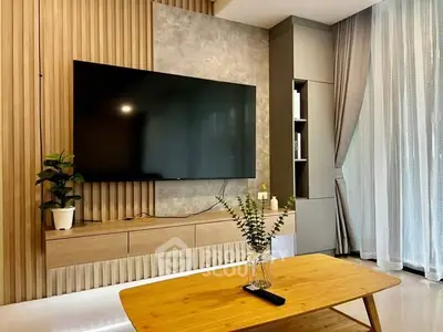 Modern living room with large TV and stylish wooden decor