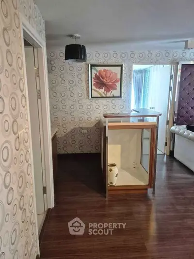 Stylish interior with modern wallpaper and elegant wooden flooring in a cozy living space.