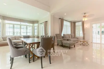 Spacious and elegant living room with modern furniture and large windows for natural light.