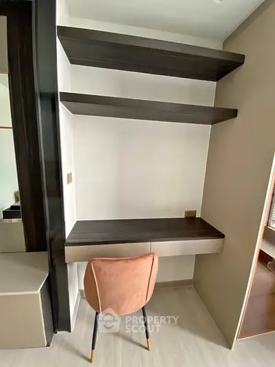 Modern study nook with sleek shelves and stylish chair in a contemporary apartment.