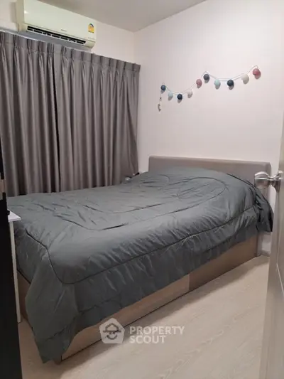Cozy bedroom with modern decor and soft lighting, perfect for relaxation.