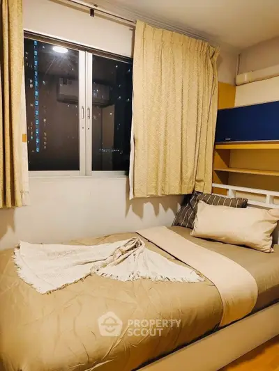 Cozy bedroom with single bed and window view in modern apartment