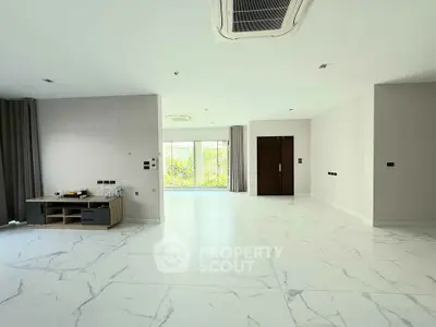 Spacious modern living room with marble flooring and large windows