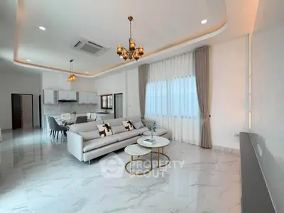 Spacious modern living room with elegant decor and open kitchen layout