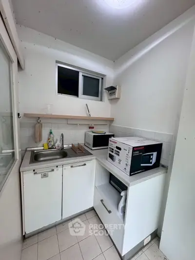 Compact kitchen with modern appliances and efficient storage solutions.