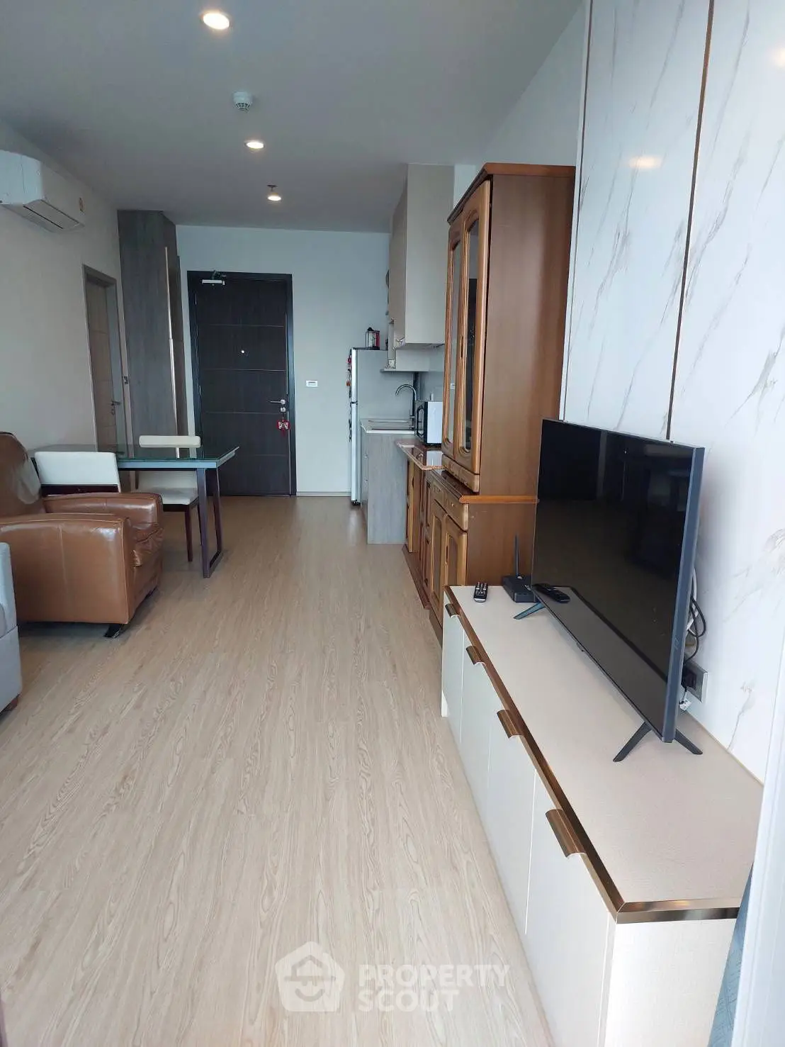 Modern living room with sleek TV setup and stylish furniture in open layout