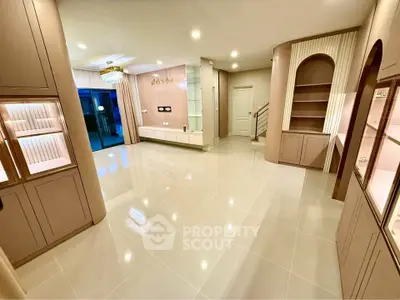 Spacious modern living room with elegant built-in shelves and glossy tiled flooring