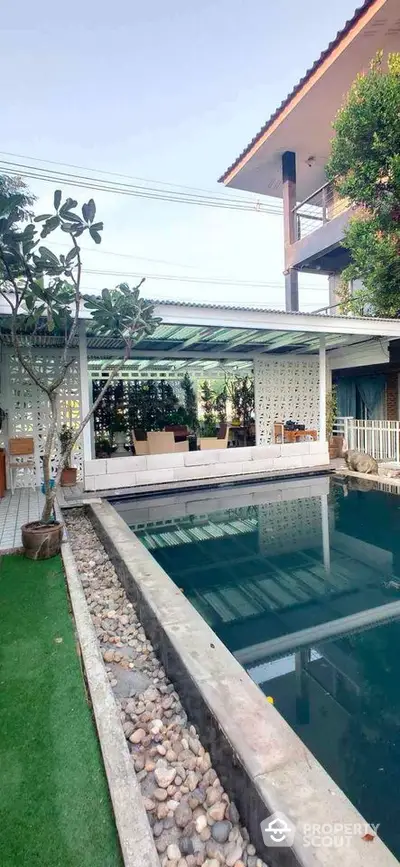 Luxurious outdoor pool area with modern design and lush greenery