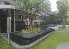 Modern apartment complex with lush garden and pool area