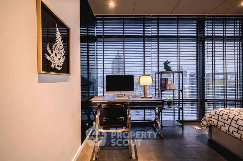 Modern study room with city view, sleek desk, and stylish decor in a high-rise apartment.