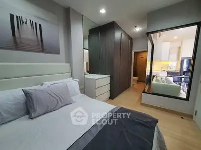 Modern bedroom with stylish decor and mirrored wardrobe in a contemporary apartment.