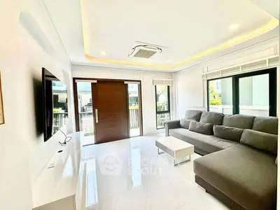 Spacious modern living room with large windows and stylish furniture