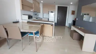 Modern kitchen and dining area with sleek design and ample storage space.