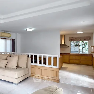 Spacious living room with open kitchen layout and modern furnishings