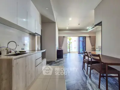 Modern open-plan kitchen and living area with sleek design and natural light.