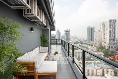 Stunning high-rise balcony with city skyline view and modern outdoor seating.