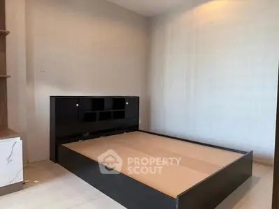 Spacious bedroom with modern bed frame and built-in storage