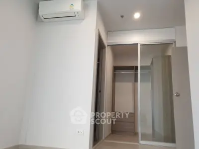 Modern empty room with built-in closet and air conditioning unit