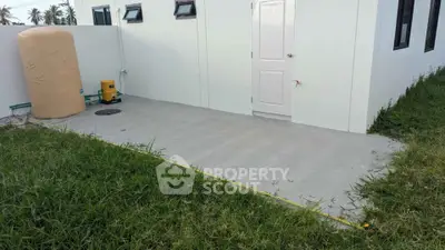 Modern exterior with water tank and pump on concrete patio