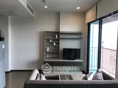 Modern living room with sleek furniture and balcony view in a stylish apartment.