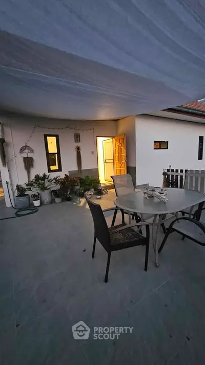 Charming outdoor patio with cozy seating and ambient lighting