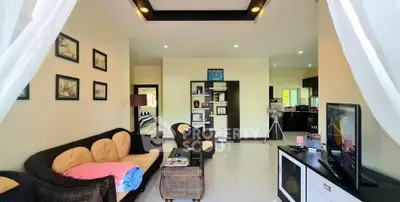 Spacious living room with cozy seating and modern decor in a bright, airy home.