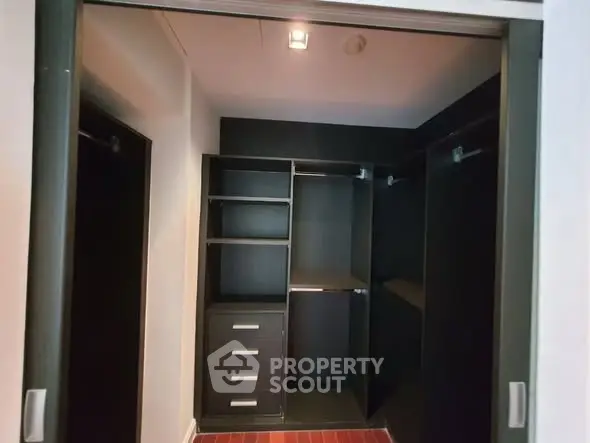 Spacious walk-in closet with ample shelving and hanging space in modern home.