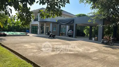 Spacious modern home with large driveway and lush greenery, perfect for family living.