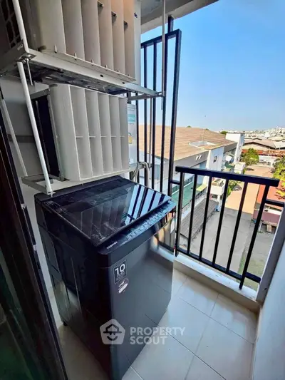 Modern balcony with washing machine and city view, perfect for urban living convenience.
