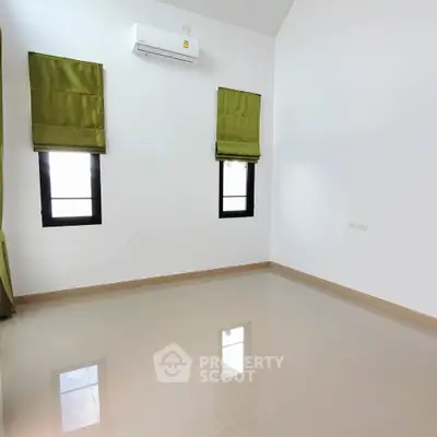 Spacious empty room with glossy tiled floor and air conditioning, ideal for customization.