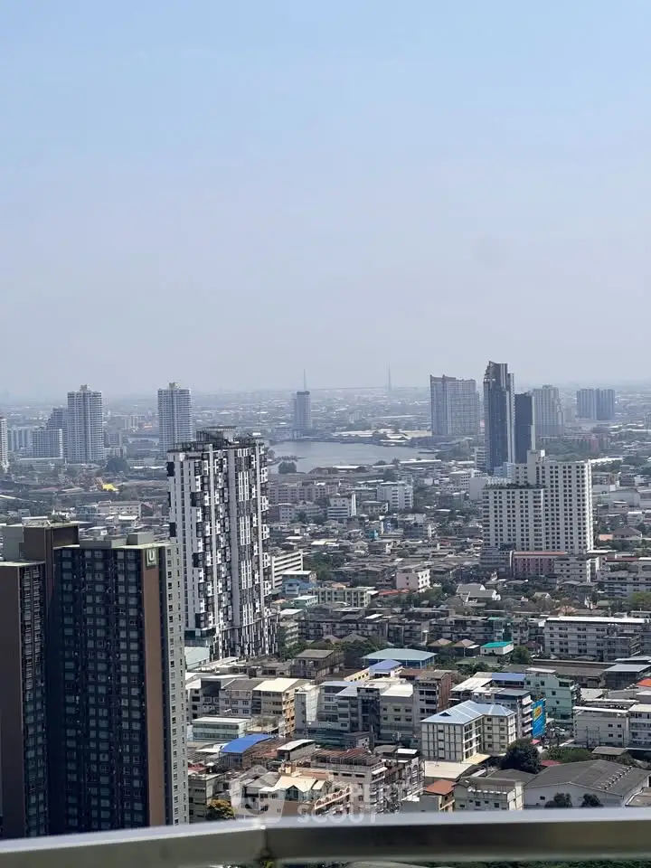 Stunning cityscape view from high-rise balcony showcasing urban skyline and distant horizon.