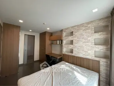 Modern bedroom with stylish decor and built-in desk, perfect for comfortable living.