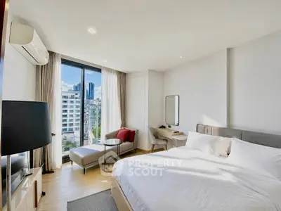 Modern bedroom with city view, featuring a cozy bed, stylish seating area, and natural light.