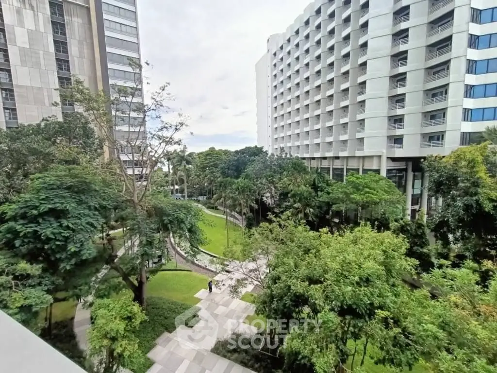 Stunning view of modern apartment buildings surrounded by lush greenery and landscaped gardens.