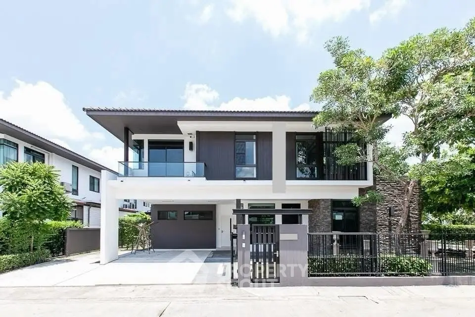 Modern two-story house with sleek design and spacious driveway in a serene neighborhood.