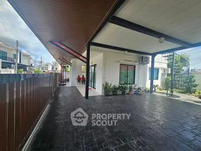 Spacious modern home exterior with covered patio and sleek design.
