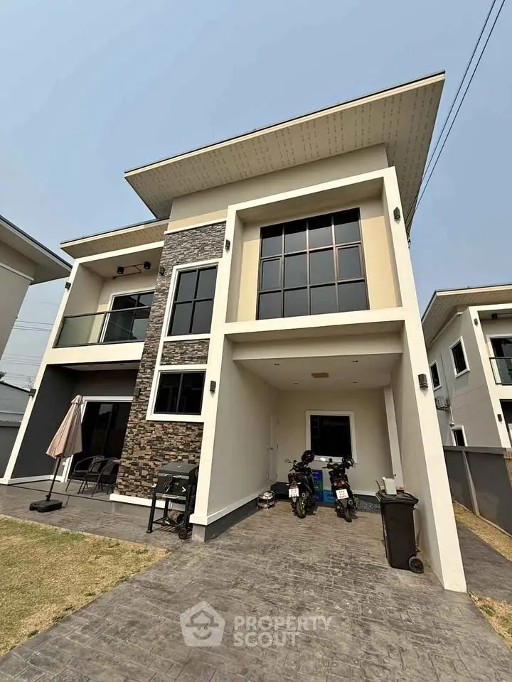 Modern two-story house with stylish facade and spacious driveway in a suburban neighborhood.